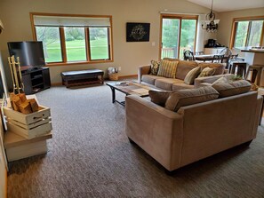 Main Living Room with wood-burning fireplace.  Beautiful golf course view.