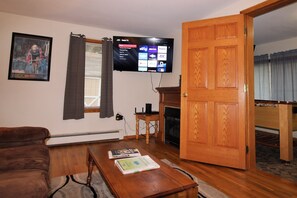 Living room with large flat screen smart TV with Roku.  Just bring your favorite streaming app and cheer on your favorite team.