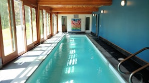 Indoor lap pool with sliders to yard