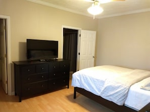 Large bedroom with smart HDTV and full bathroom.