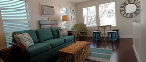 Living Room with dining table stools. Couch is a pull out