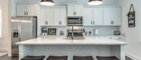 Kitchen fully stocked with all cooking essentials, oven, dishwasher, microwave, stove and drop coffee maker