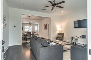 Spacious living room with comfortable queen sofa bed, loveseat and smart t.v.