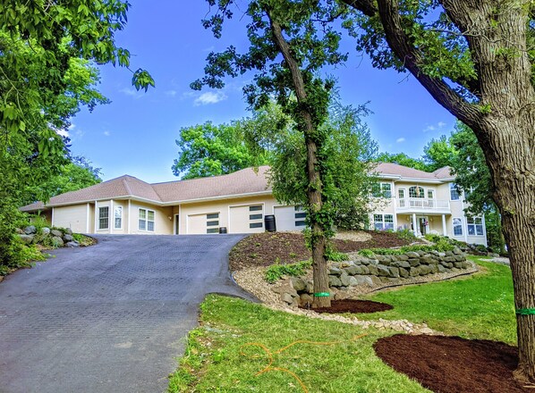 The rental unit is located to the left of the garages with its own entrance