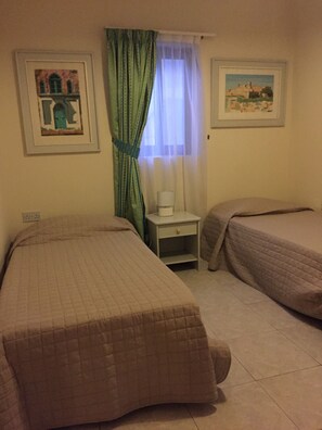 Double bedroom, with two single beds and a wardrobe 