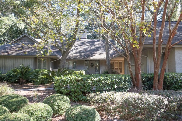 Near beach one story well kept home in lush greenery and Cougar golf course