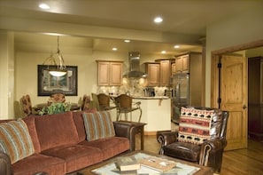 Main floor living/kitchen area - fully-stocked gourmet kitchen