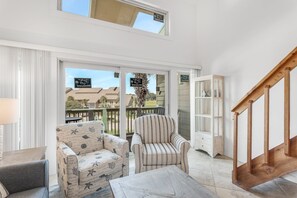 Living area leads out to deck overlooking pool