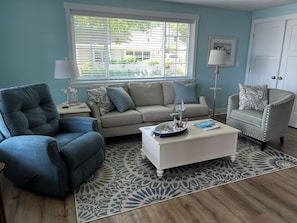 Living Room with  sofa, recliner, and occasional chair.  Laundry closet.