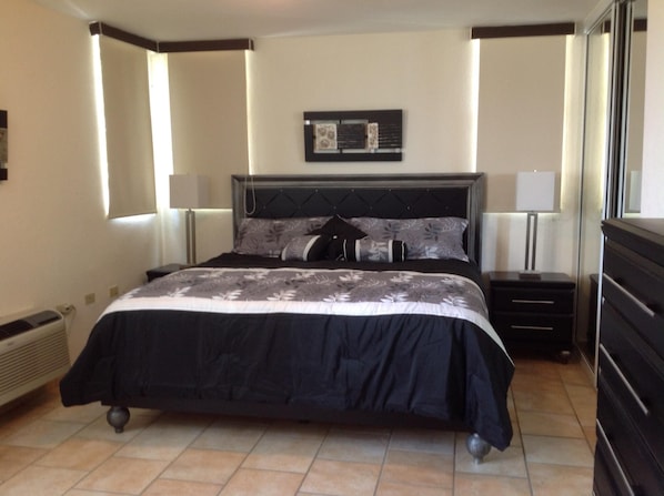 Master bedroom has king size bed and private bathroom.