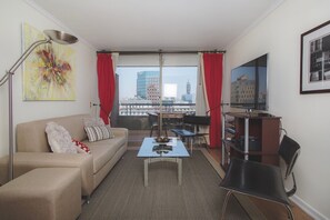 Spacious living room with balcony to the city and mountains