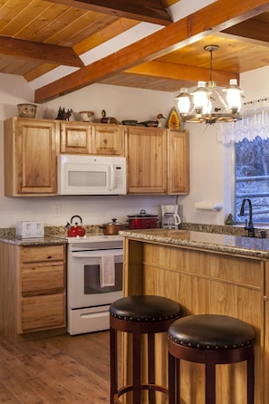 Fully stocked kitchen with views of the pines