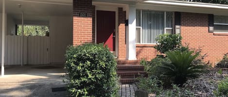 Front door, also shows part of covered carport (two cars)