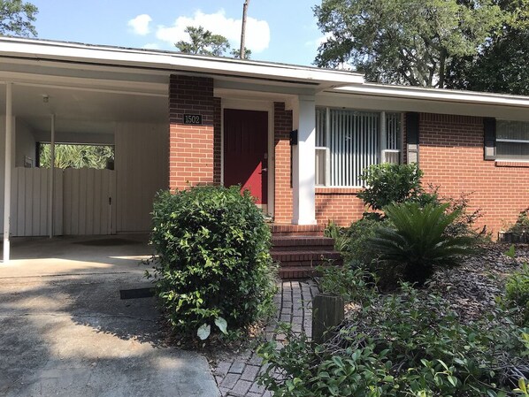 Front door, also shows part of covered carport (two cars)