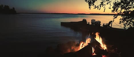 Waterfront fire pit at sunset