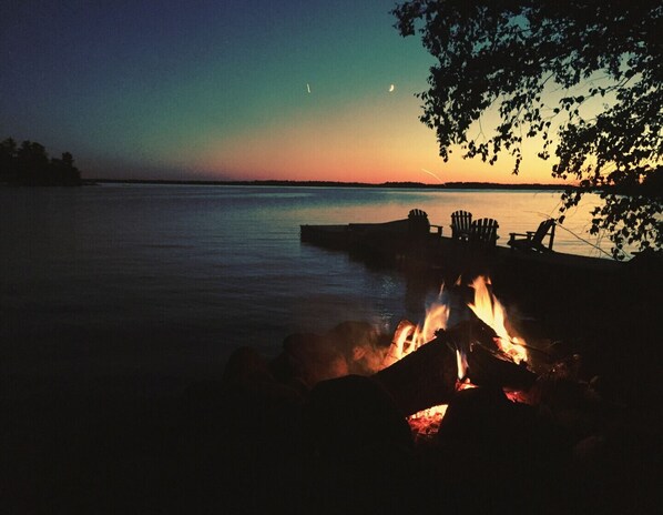 Waterfront fire pit at sunset