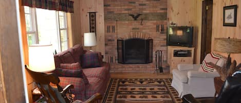 Inviting living room made cozy with the fireplace, tv with dvd.