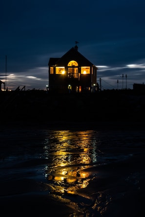 Twilight view of The Shack from the beach at low tide