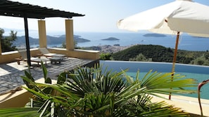 Pool-side pergola offers shelter from the sun for a nap or to enjoy your book