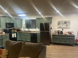 Large kitchen with dishes, pots, and staples you need for cooking 