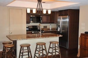 Newly remodeled kitchen with stainless appliances and breakfast bar.