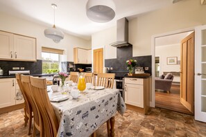 Kitchen with electric cooker and hob, microwave, dishwasher, tall fridge