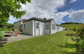 Garden looks over grass fields and woodland. An enclosed courtyard provides safe freedom for children and dogs
