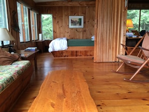 Living room looking toward queen bed in sleeping alcove