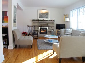 Bright sunlight streams in, and the woodburning fireplace lends its warmth.  