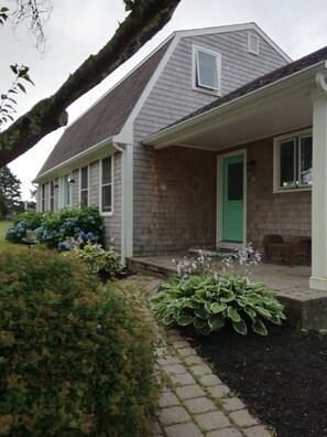 The entrance door from the upper driveway. Leads into the kitchen.