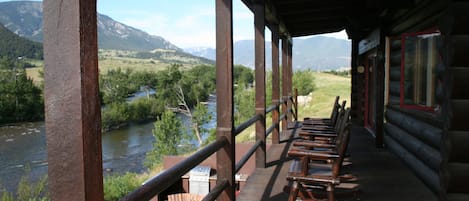 Long upper deck overlooking the Stillwater River & stone patio w/outdoor kitchen