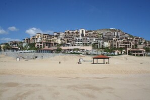 PB SUNSET BEACH RESORT showing beach front and hillside condos.