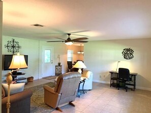 Family room with desk work area and 52” television and DVD player.