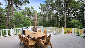 Large deck with dining table and gas grill