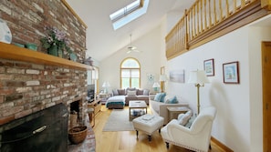 Open main living area with skylights and vaulted ceiling