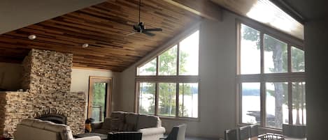 Large open main living area! Stone fireplace and windows overlooking the lake. 