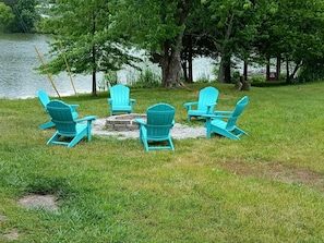 Adirondack chairs around the fire pit. Bring wood or purchase locally. 