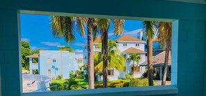 Balcony outside upstairs bedrooms overlooking the pool and garden.