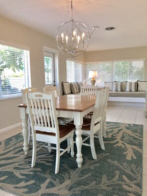 Dining area with built in couches that convert to 2 twin beds
