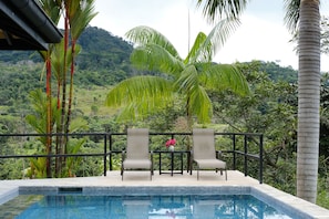 Relax here on your private deck next to pool while listening to the river below 