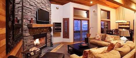 Living room with wood burning fireplace, 42" plasma tv, dvd, and stereo.