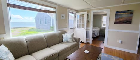 Living room with comfortable sectional and views of Wellfleet Harbor