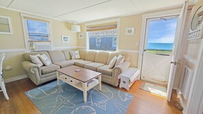 Living room with comfortable sectional and Wellfleet Harbor views