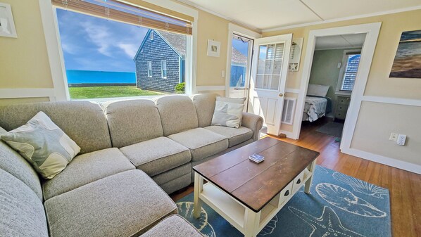 Living room with comfortable sectional and Wellfleet Harbor views