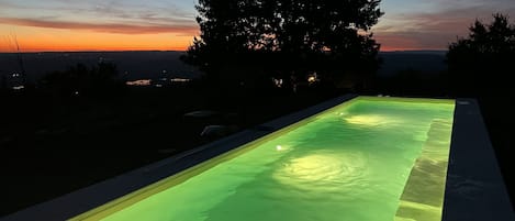 The new pool at sunset. A 14 m saltwater lap pool with a bench on the side.