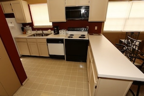 Kitchen equipped with full size appliances.