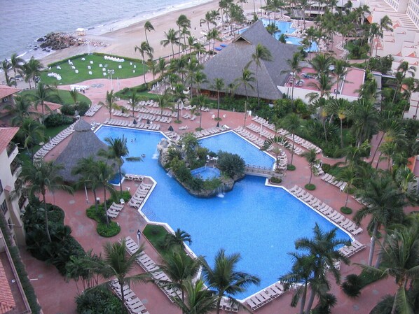 View of the pool from the balcony. Swim up bar and hot tube.