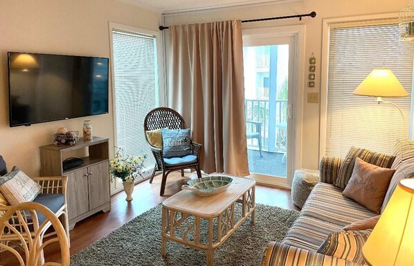 Living room with sleeper sofa and private screened balcony