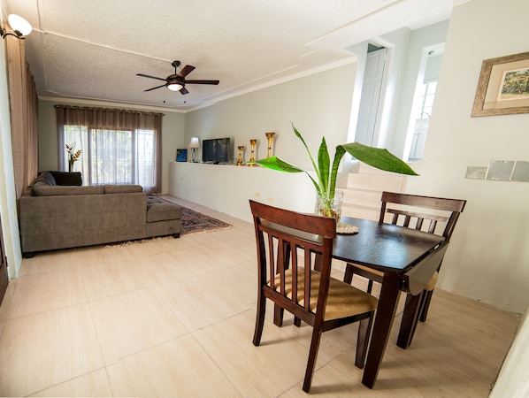 Large living room area with dining table
