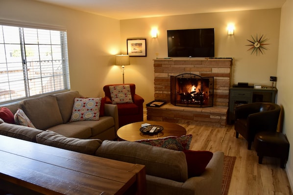 Family Room with cozy gas-buring fireplace and large smart TV.